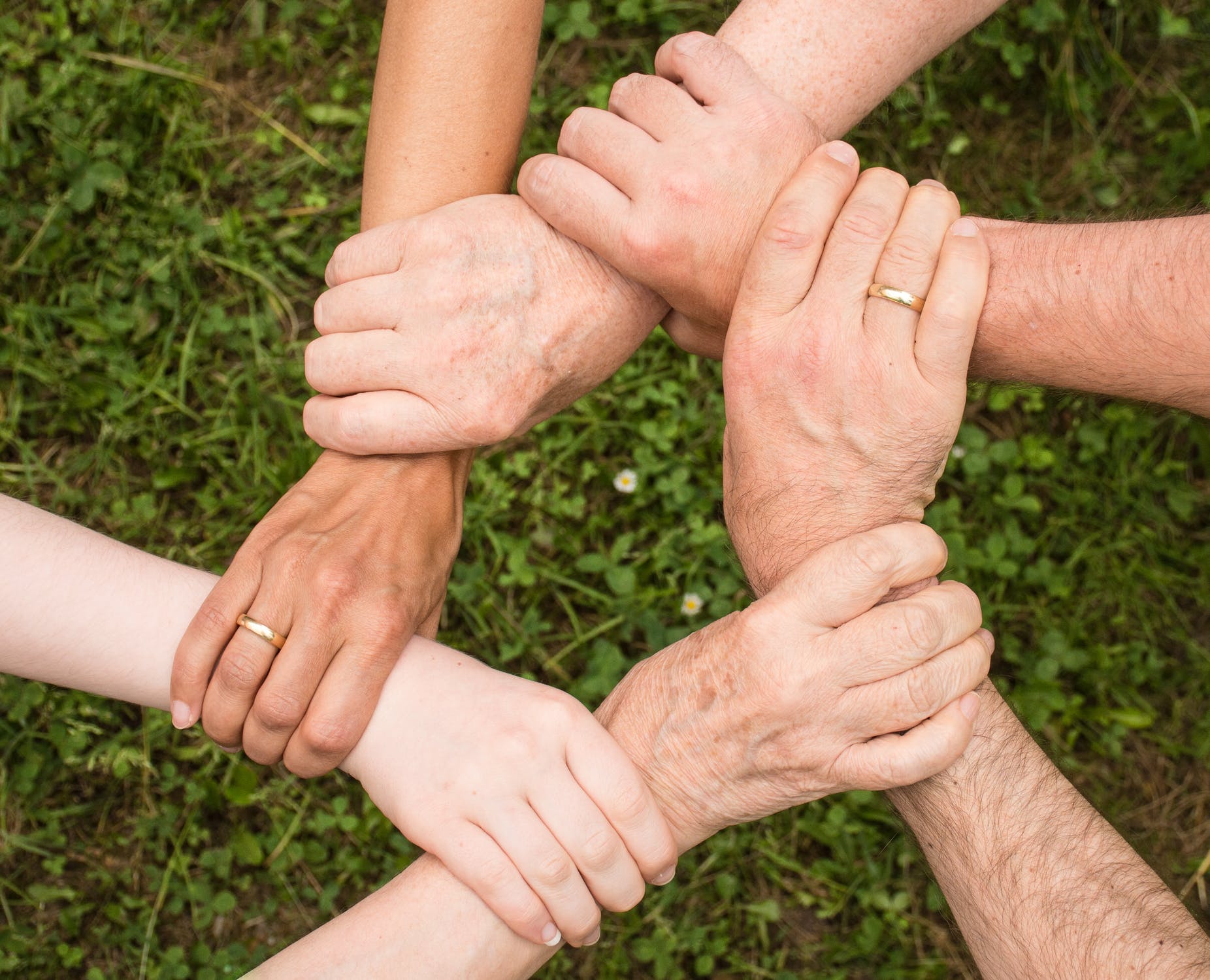 Our office workers making a community symbol with our hands.