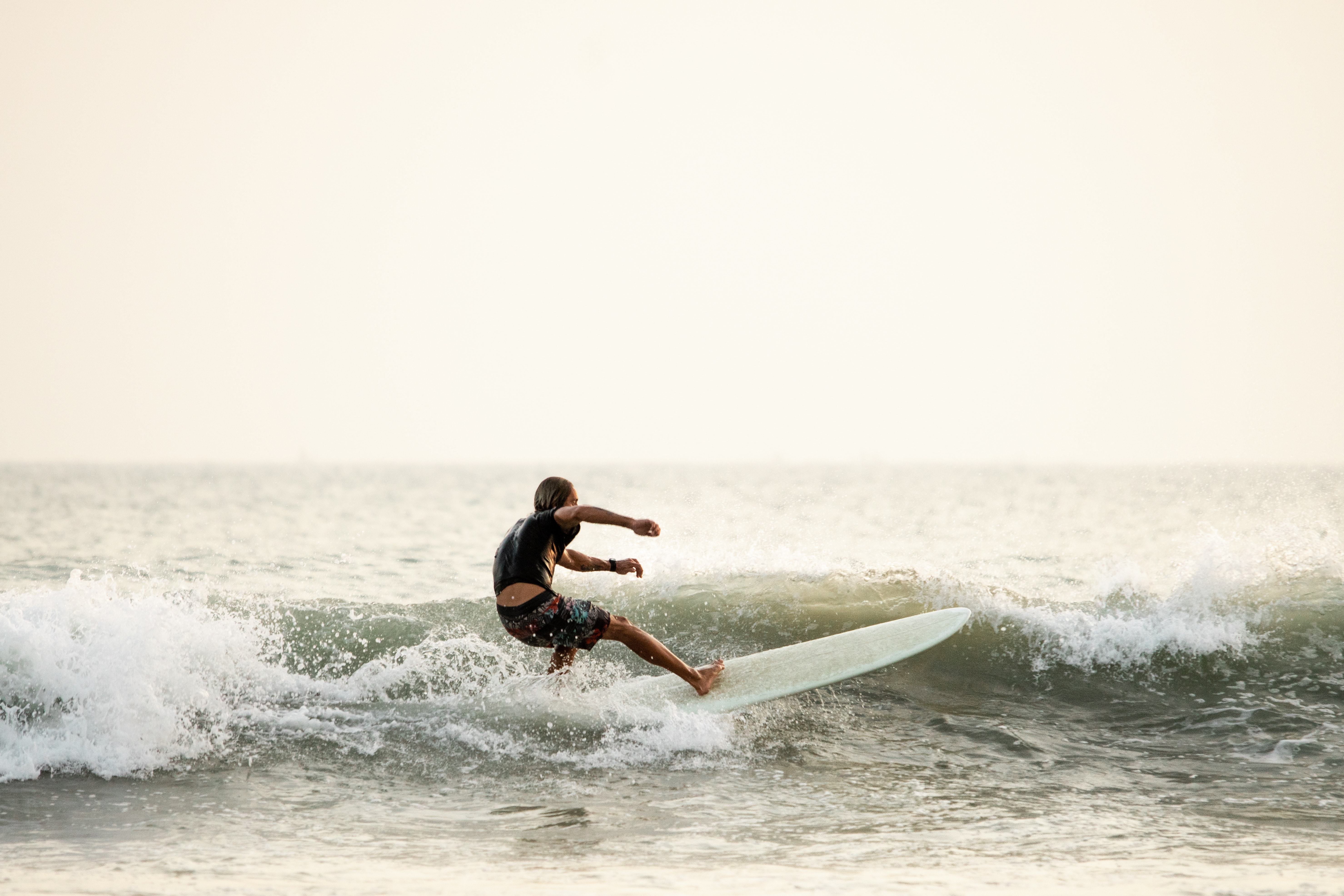 One of the instructors in the water before a surfing summer camp